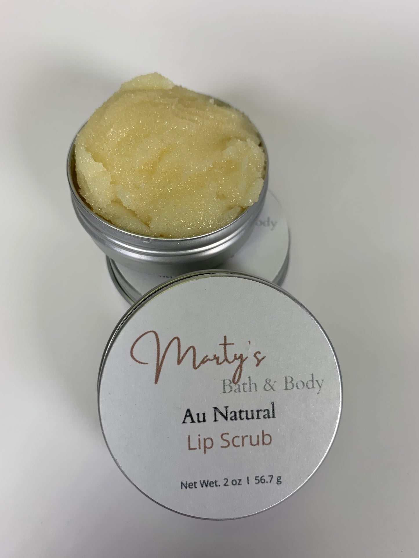Tin of Au Naturel Lip Scrub with a sample to give an idea of the consistency of the product.