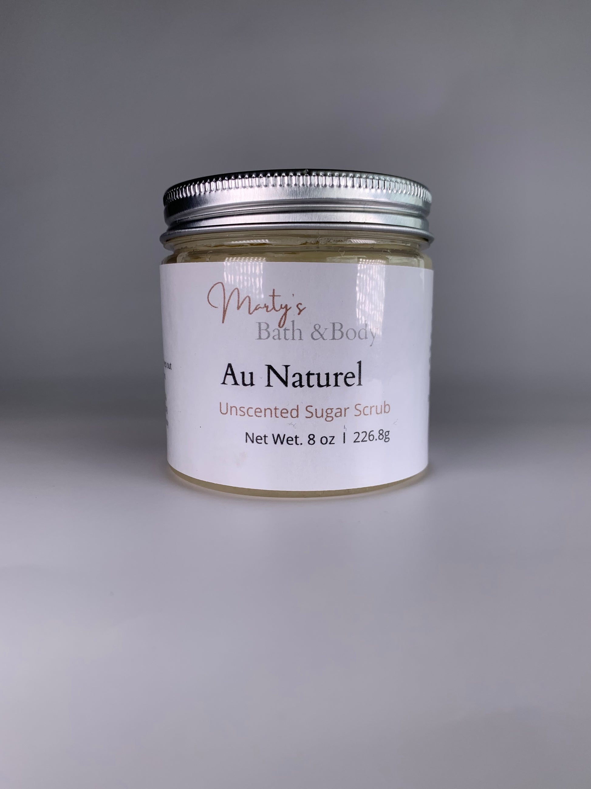 8oz jar of Au Naturel unscented natural sugar scrub.