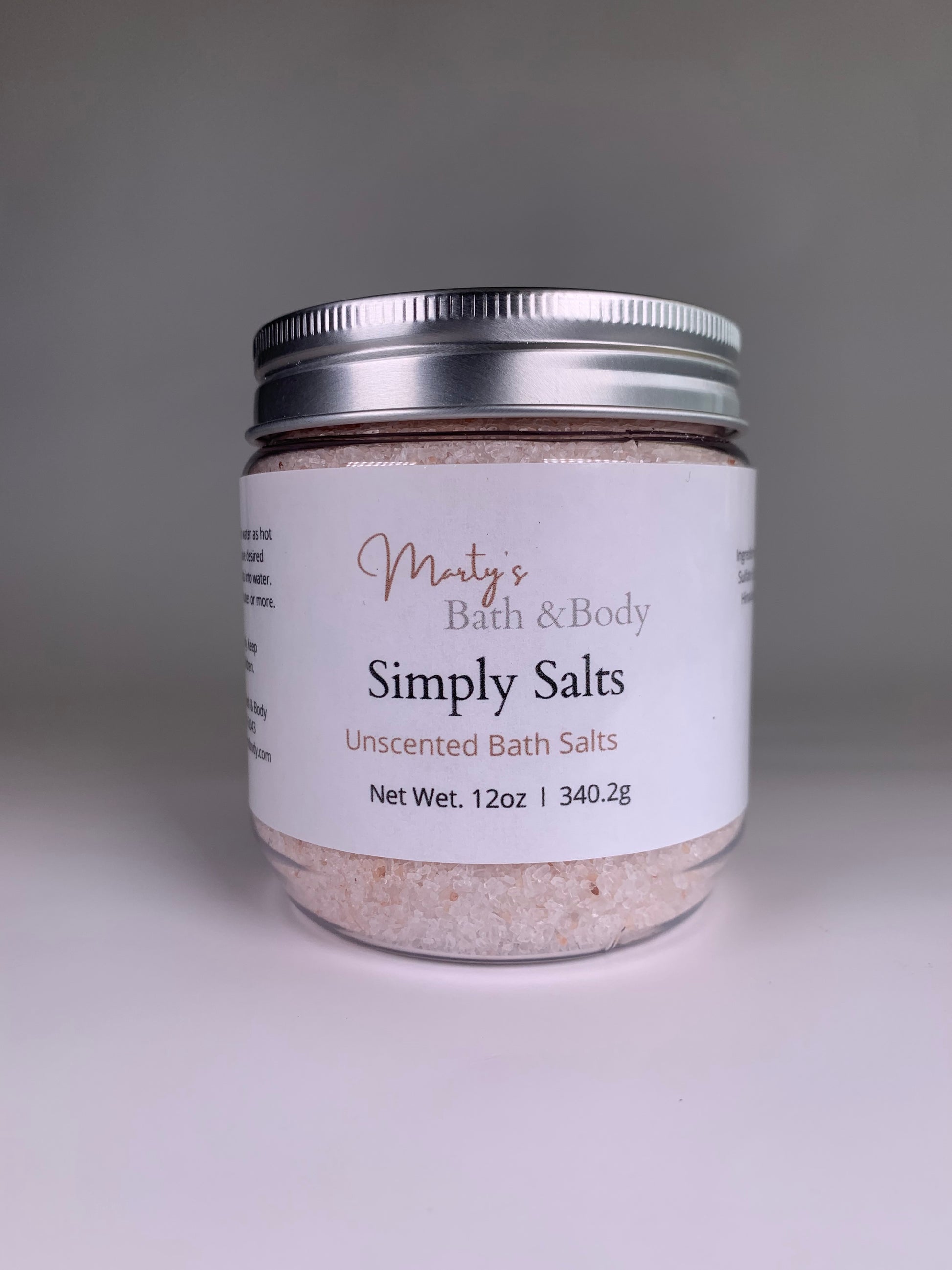 The front of a 12oz jar of Simply Salts. An all natural, unscented bath salt/bath soak.