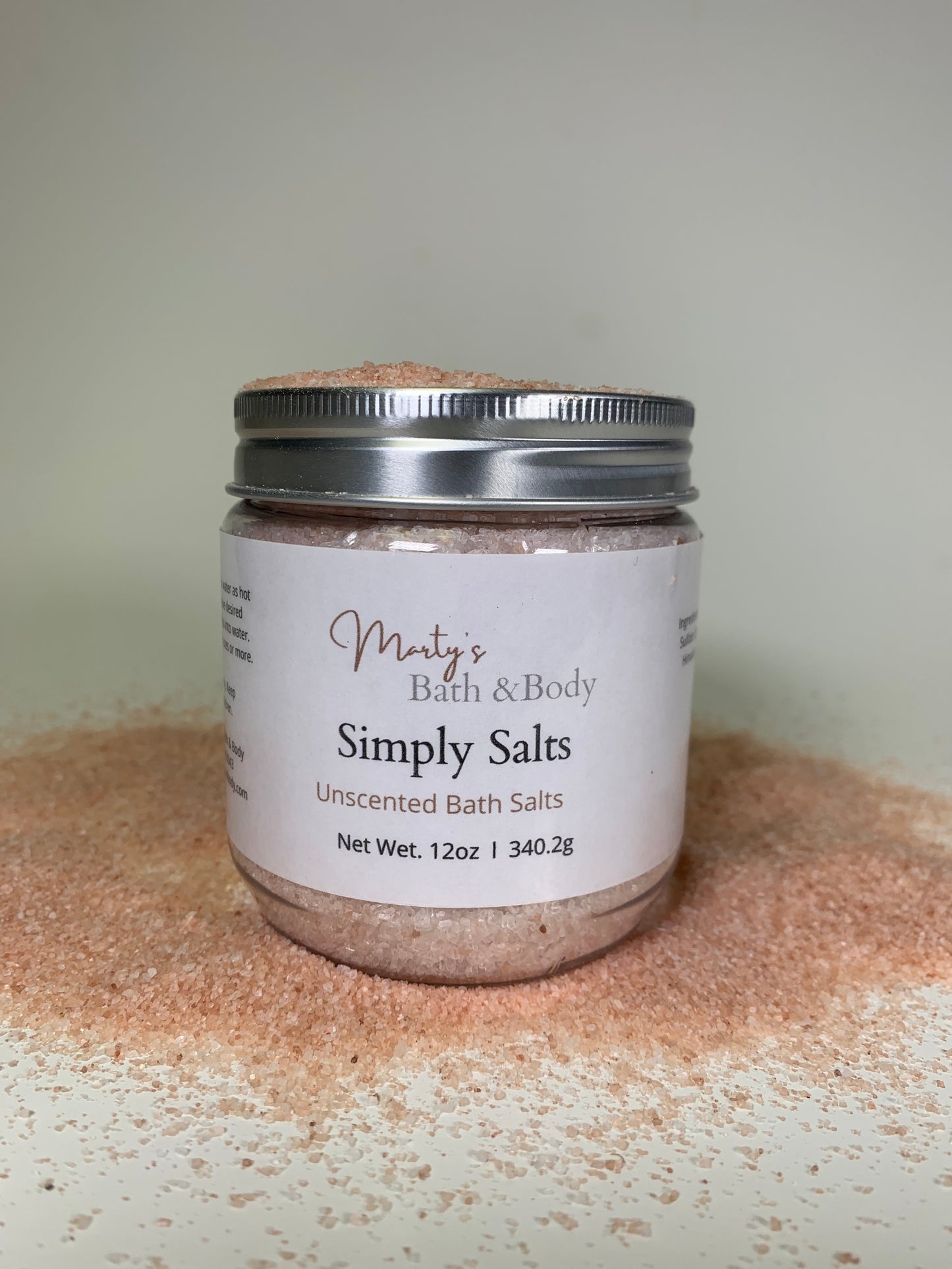 A 12oz jar of Simply Salts. Handmade bath salts surrounded by Himalayan pink salts.