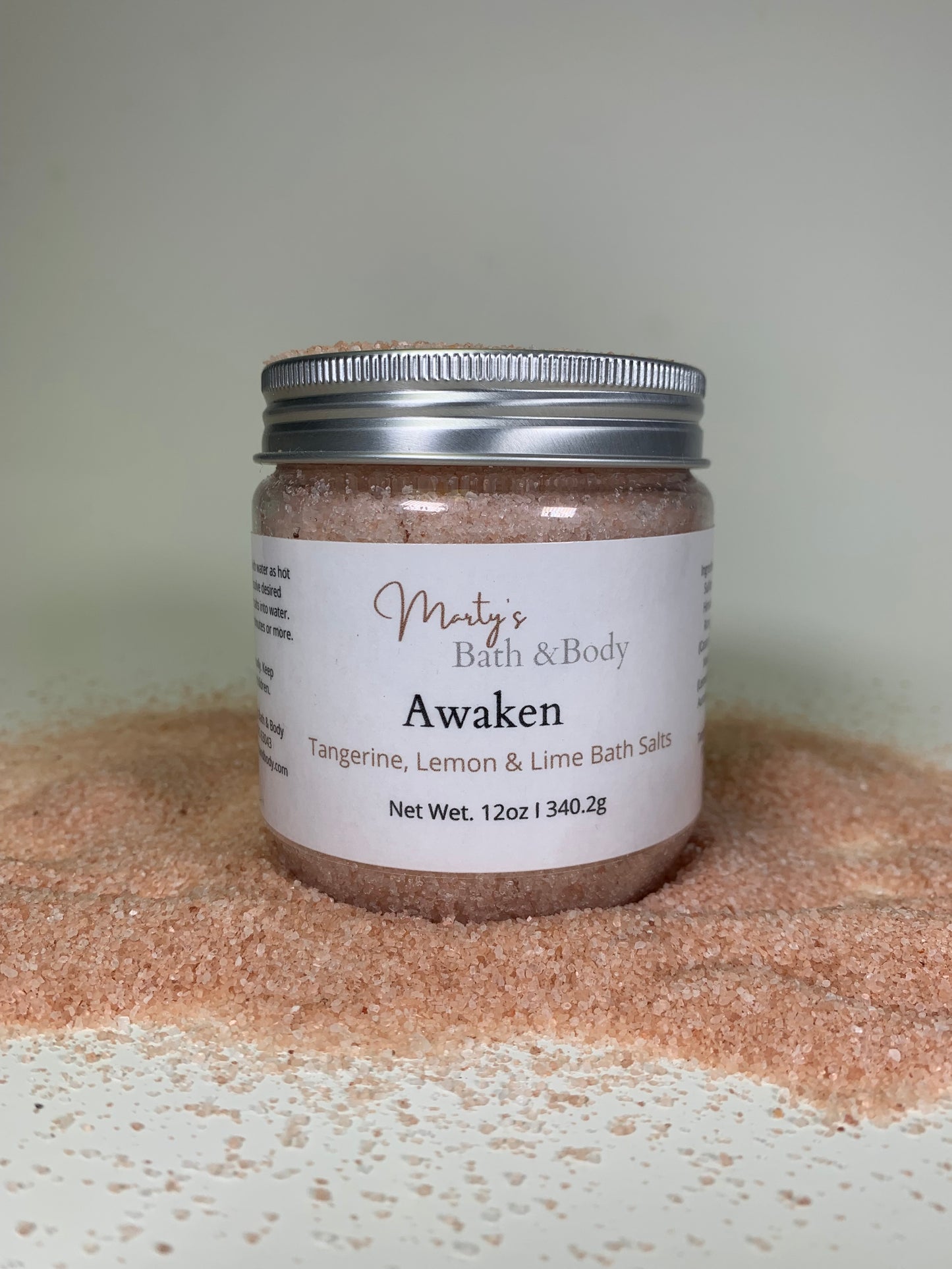 12 oz jar of Awaken bath salts/bath soaks. Made with natural salts and pure tangerine, lemon and lime essential oils.