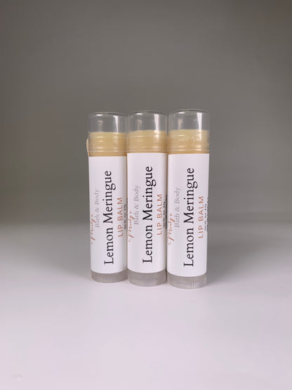 Three plant-based lemon meringue flavored lip balms placed standing up.