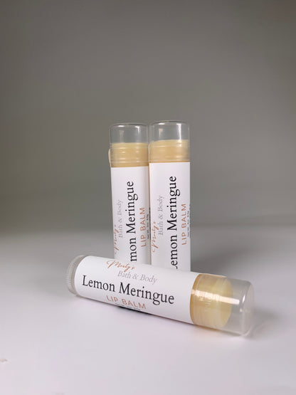 Three lemon meringue lip balms. Two standing up, the third lying down. All vegan ingredients.