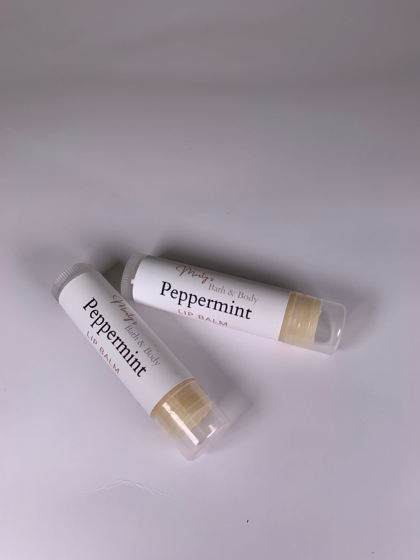 Two tubes of all natural, plant based peppermint lip balm.