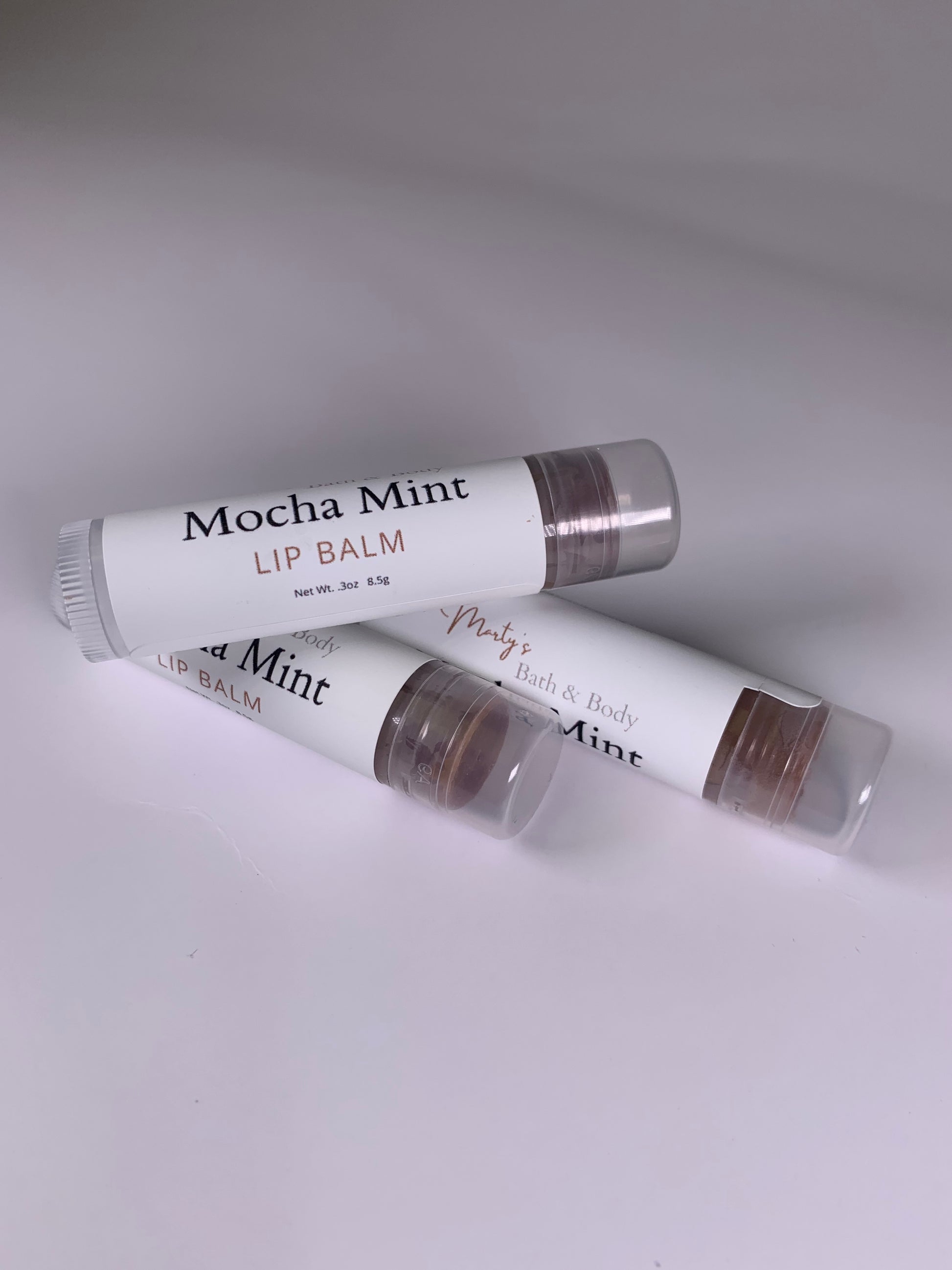 Three tubes of vegan mocha mint lip balms.