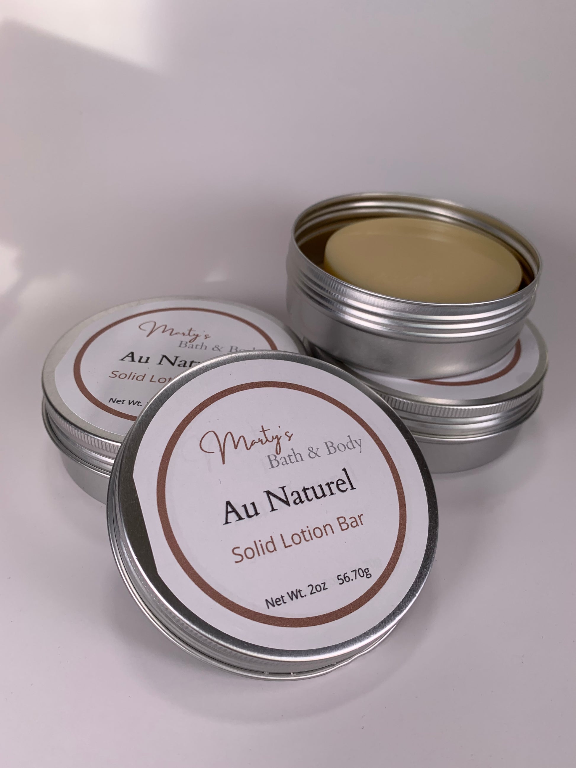 Three recyclable containers of Au Naturel (unscented) all natural solid lotion bars.